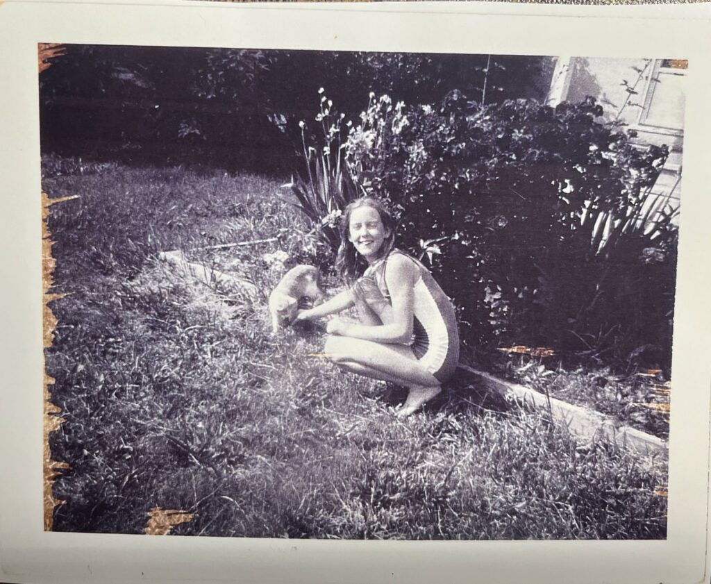 Theresa in swimsuit with cat in back yard.